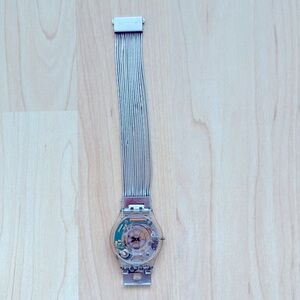 Swatch ultra thin watch has an silver bracelet